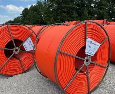 A group of standard HDPE conduits in a parking lot.